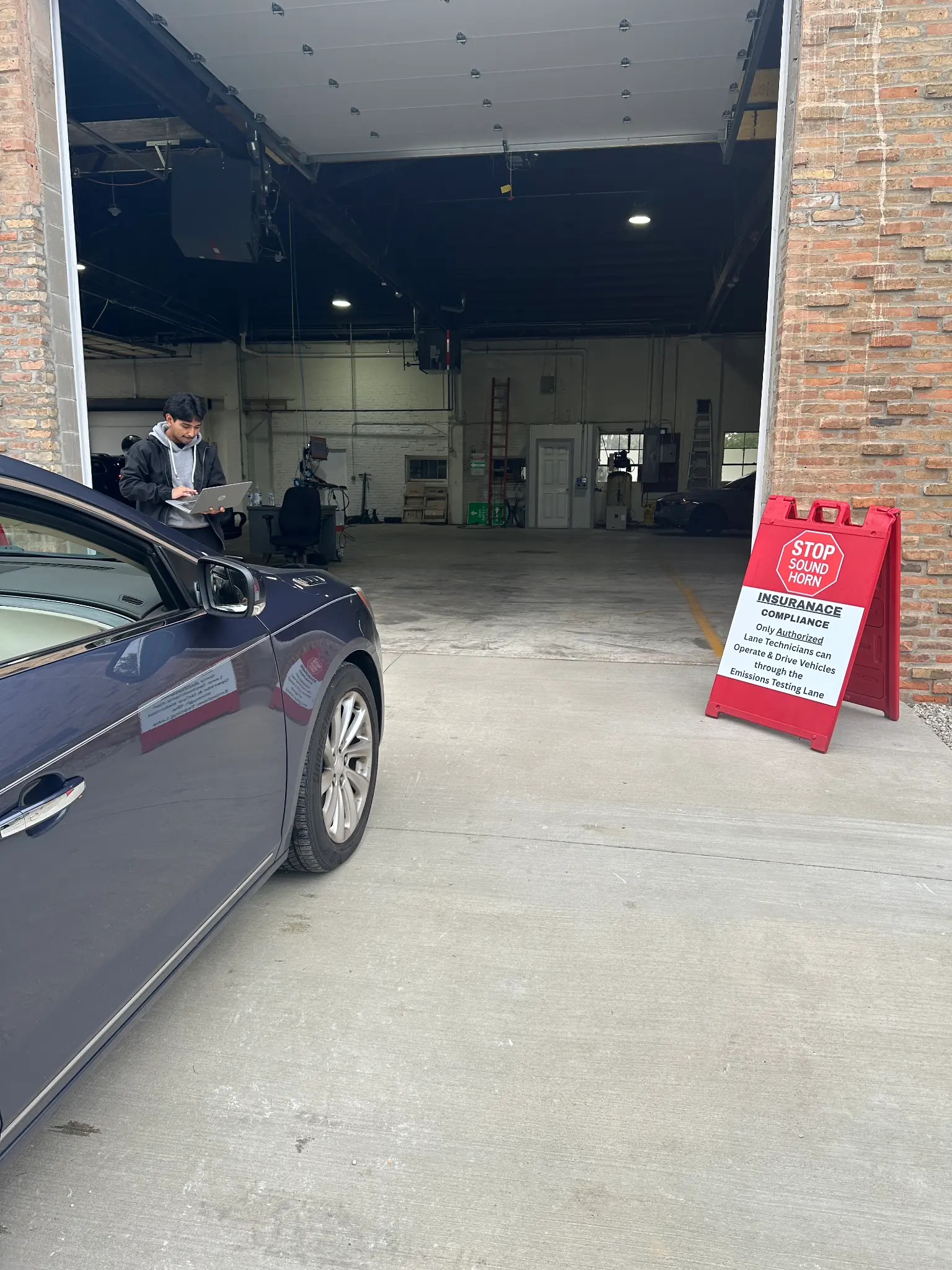 Drive-in entrance for vehicle emissions testing at Waukesha Emissions Testing Station